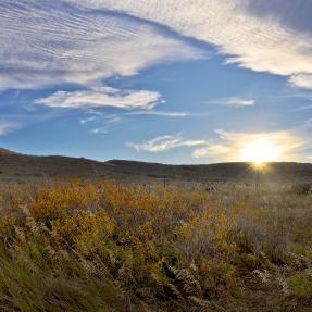 Sun sets over western Boulder Valley Ranch north of Boulder