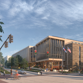 Rendering of the new Western City Campus building. Couple story building with large glass windows surrounded by stone siding with a welcoming, large entrance area.