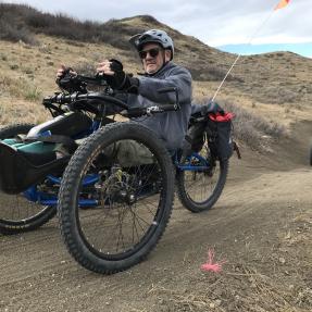 Handcyclists riding on a dirt trail 