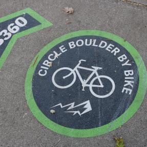 B360 Marking on pavement that says B360 circle boulder by bike with bike graphic