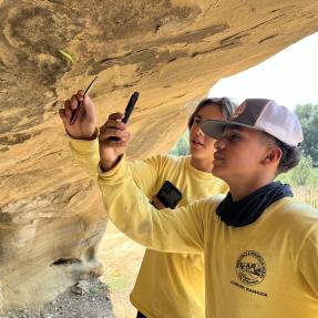 Junior Rangers use hand lenses to observe a rock formation