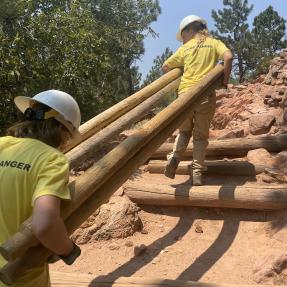 Junior Rangers haul fence logs up Mount Sanitas